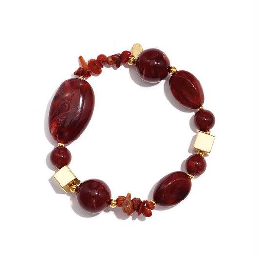 Statement bracelet with mixed deep wine-red beads, organic chip details and gold accents