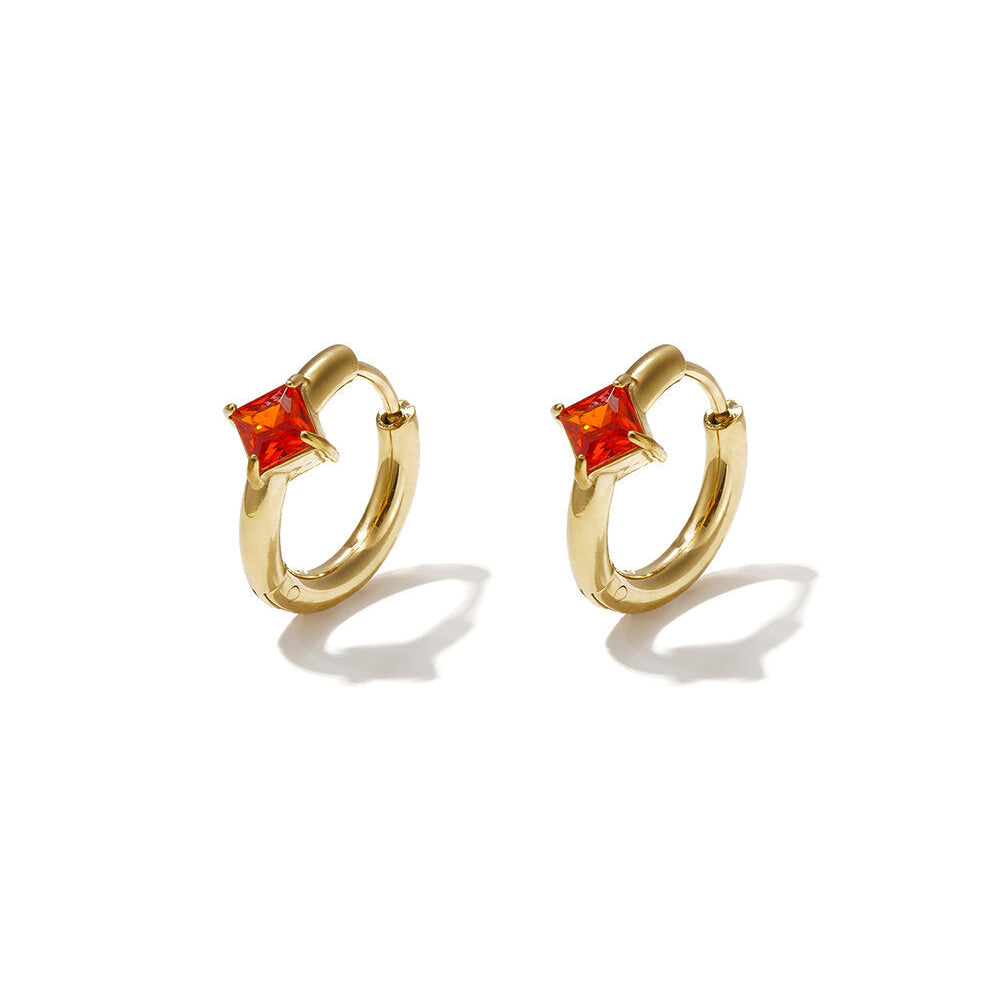 Gold huggie earrings with square burnt-orange zircon stones.
