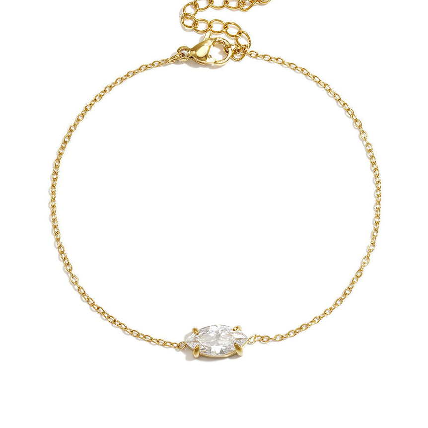 Fine gold chain bracelet with a single marquise-cut clear stone and extender.