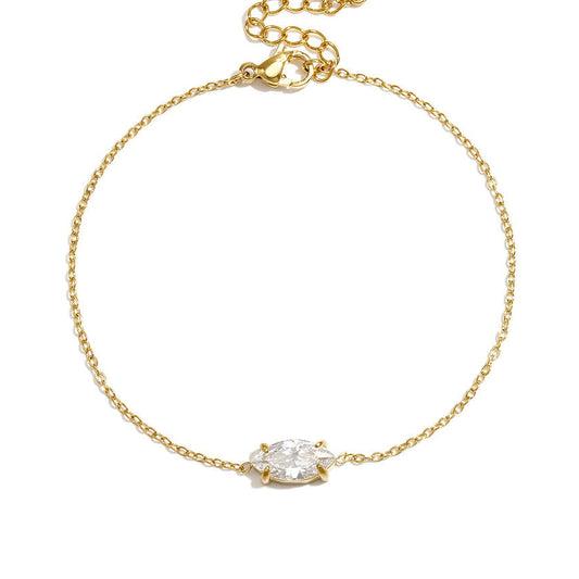 Fine gold chain bracelet with a single marquise-cut clear stone and extender.