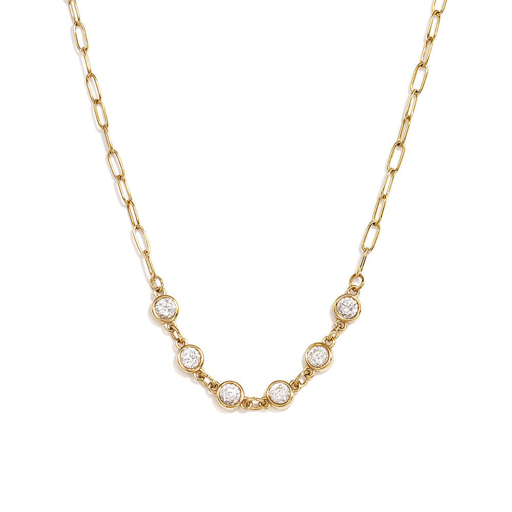 Gold paperclip chain necklace with five clear round bezel-set stones.
