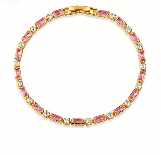 Gold-tone tennis bracelet with alternating pink baguette-cut stones and round clear crystals in a sleek, elegant design
