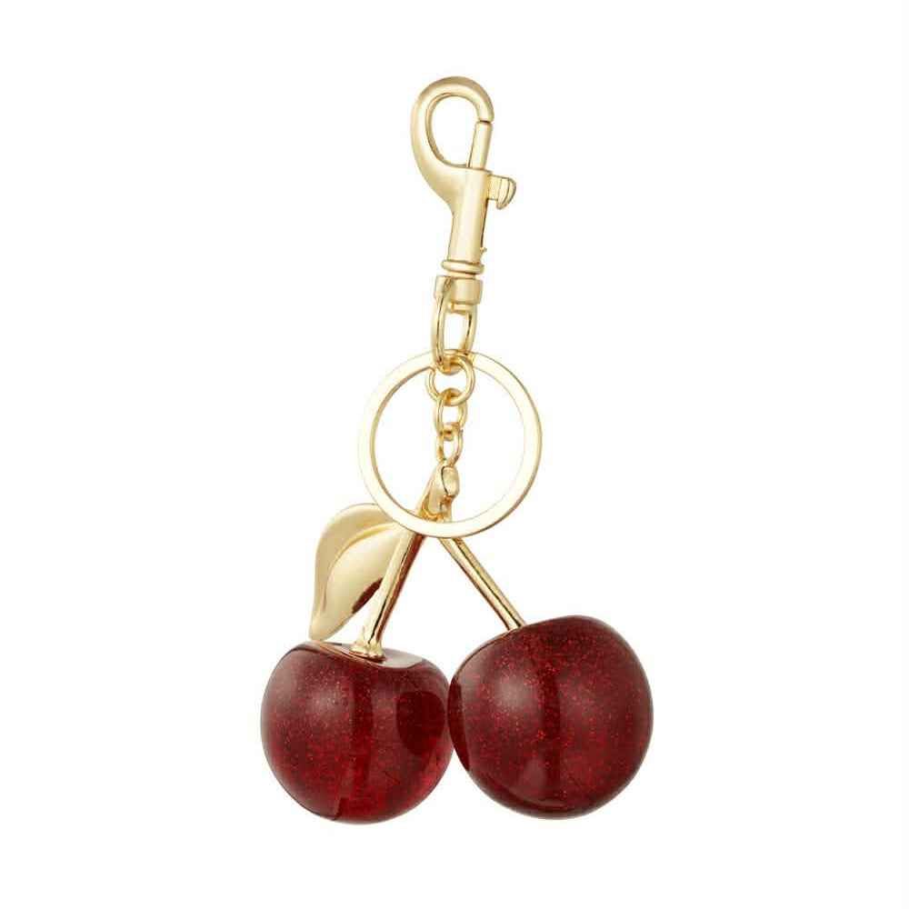 Gold keychain with two glossy red cherry charms and leaf detail on white background