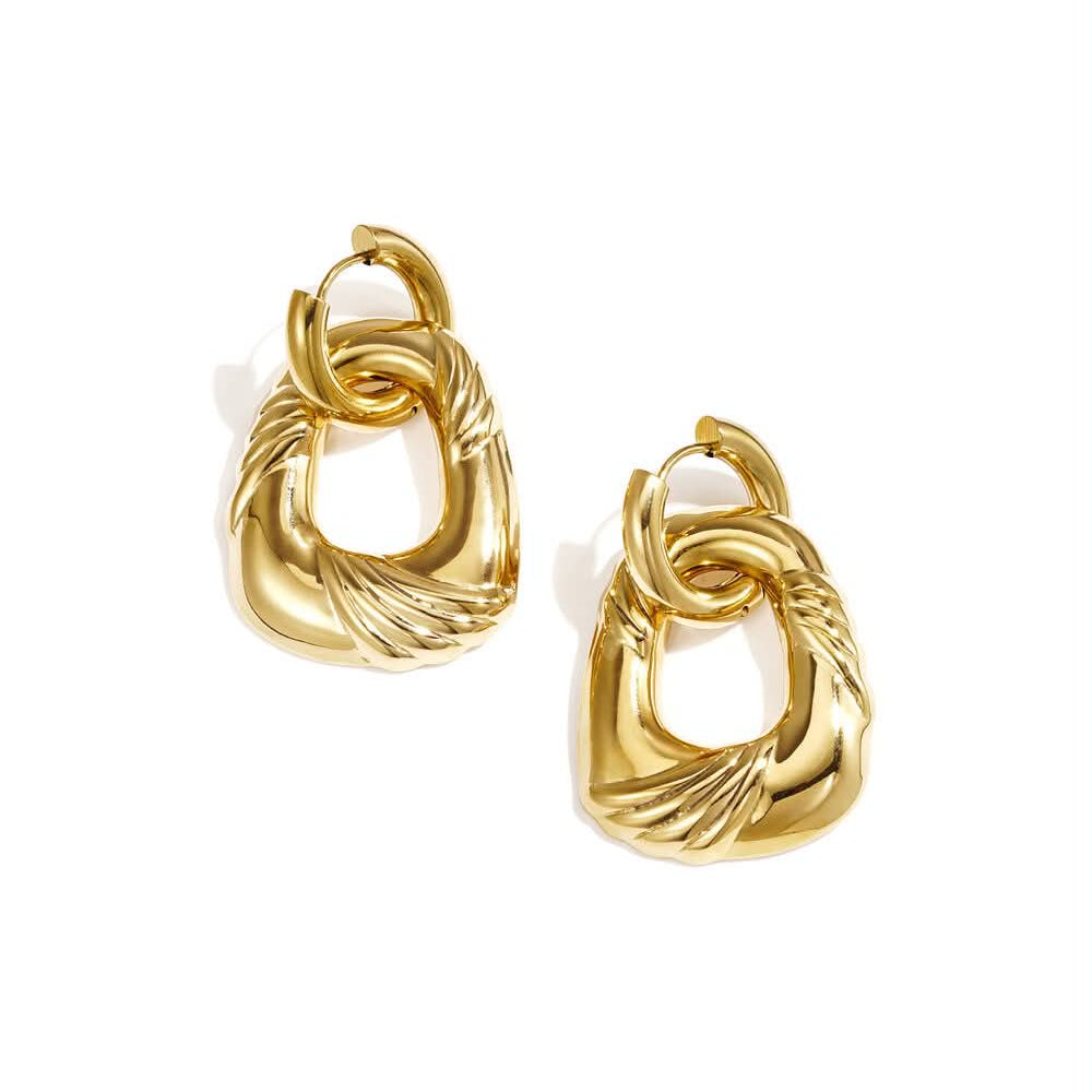 Gold statement drop earrings with layered open forms and ribbed vintage-inspired detailing