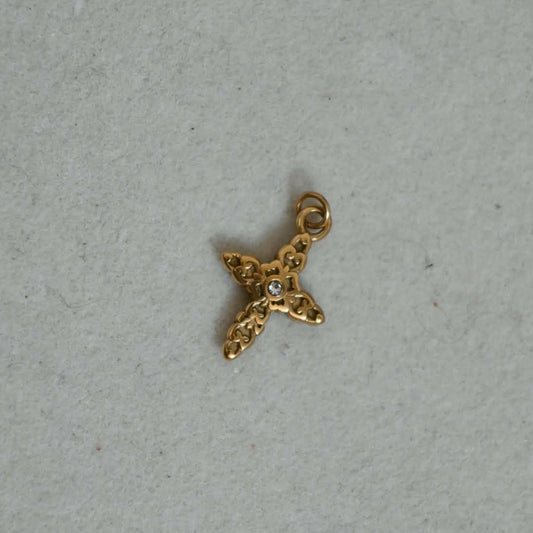 Gold cross charm with intricate detailing and a central crystal, suitable for charm bracelets and necklaces