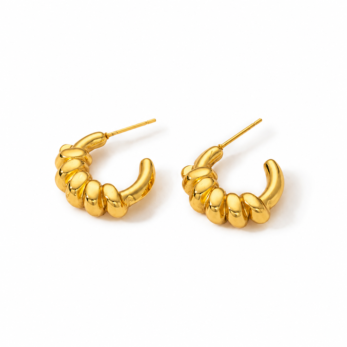 Gold sculptural twisted hoop earrings with chunky croissant-inspired design