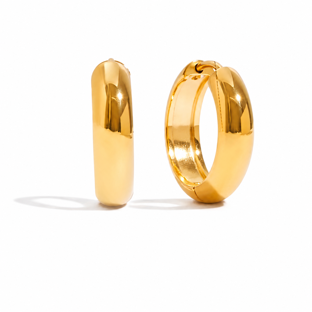 Chunky polished gold hoop earrings with a smooth rounded silhouette
