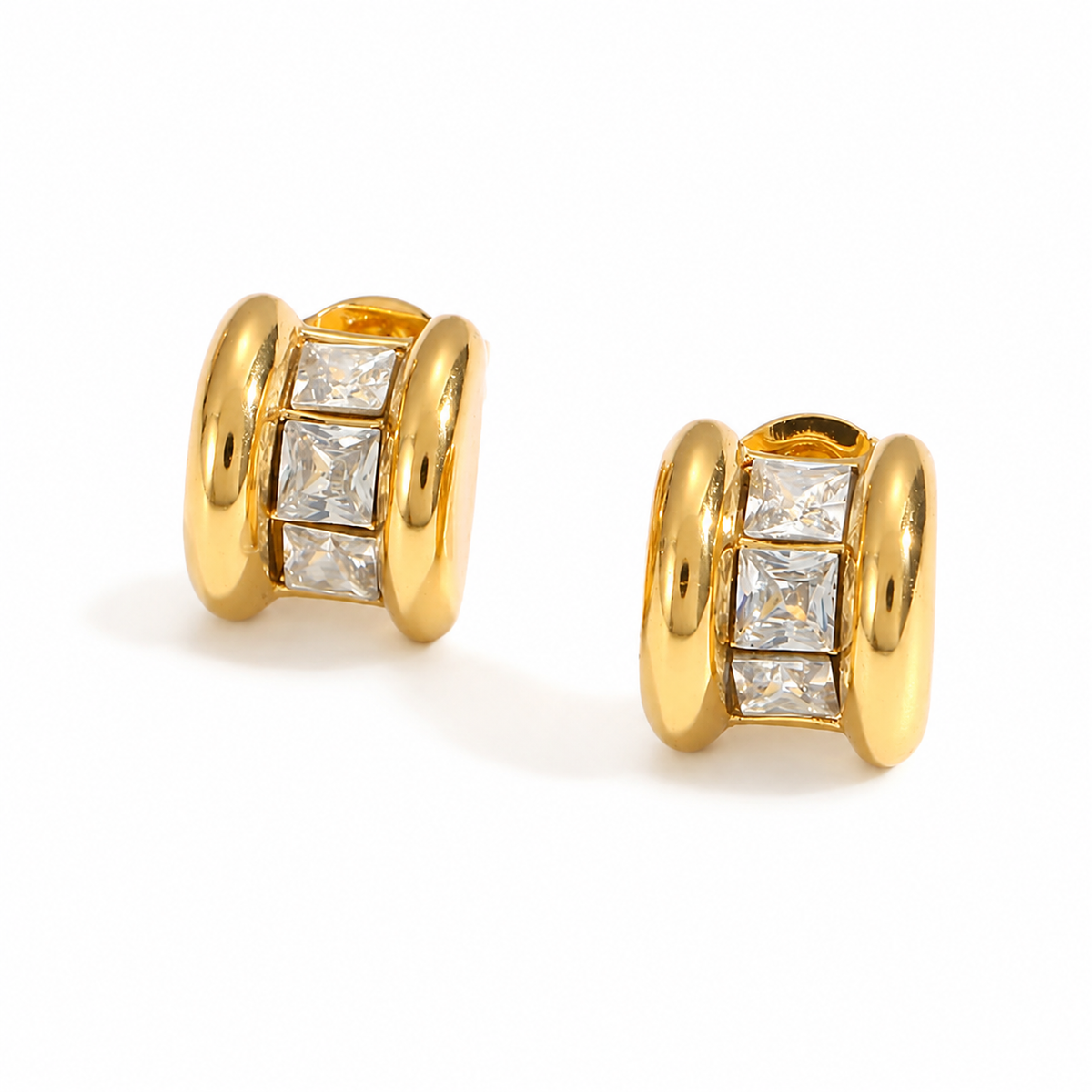 Small chunky gold studs earrings featuring three square-cut clear crystals set between polished gold edges.