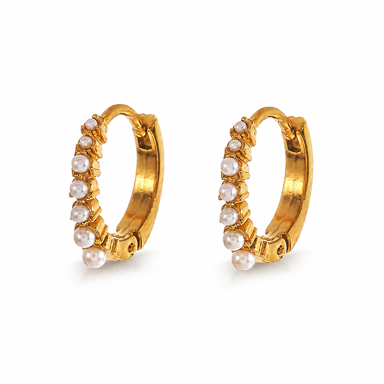 Petite gold beaded huggie hoop earrigs decorated with delicate white pearls.
