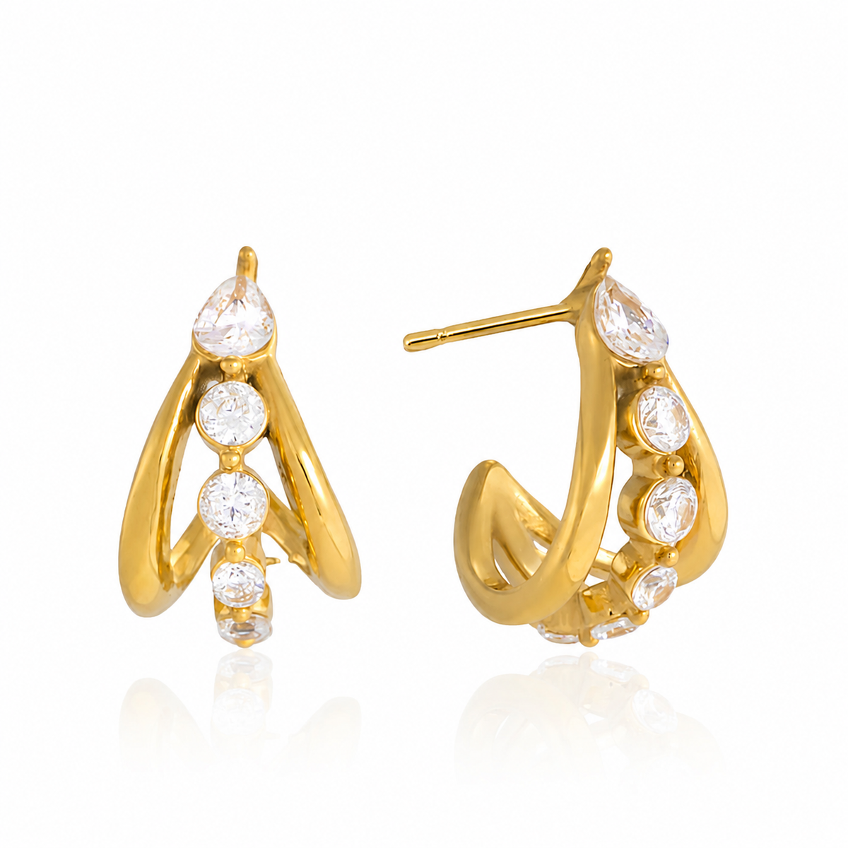 Gold sculptural hoop earrings with intertwined curved detailing and a row of clear sparkling crystals
