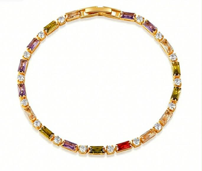 Gold-tone tennis bracelet with alternating multi colour baguette-cut stones and round clear crystals in a sleek, elegant design