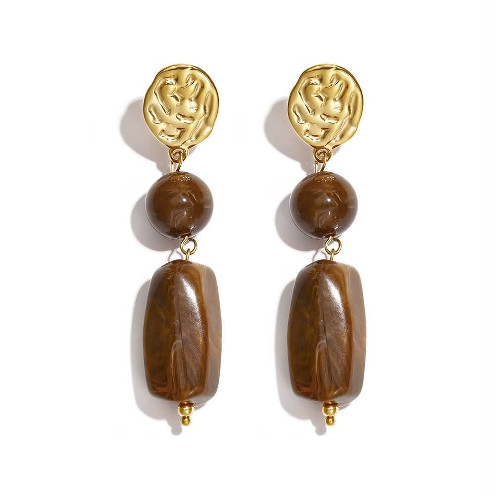 Gold statement drop earrings with sculptural textured studs and marbled caramel-brown beads.
