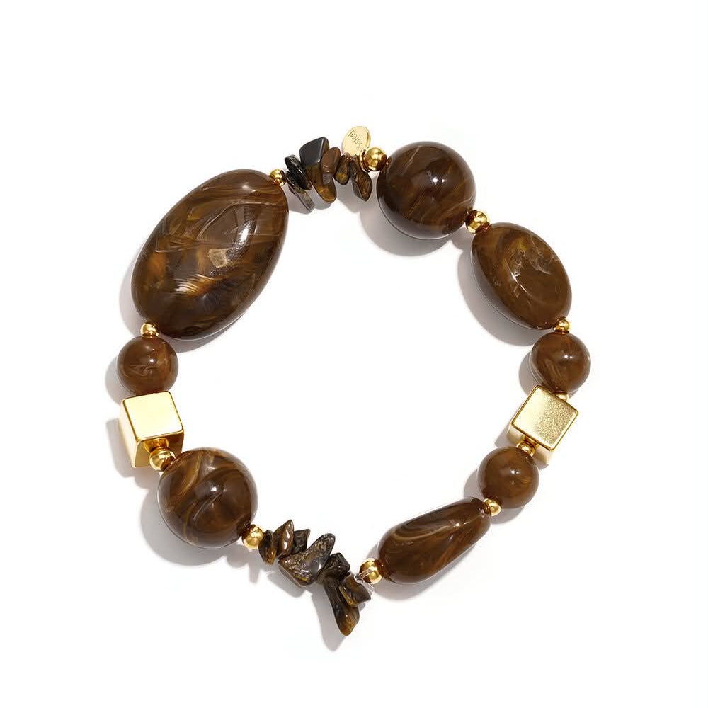 Statement bracelet with mixed marbled chocolate-brown beads, organic chip details and polished gold accents.
