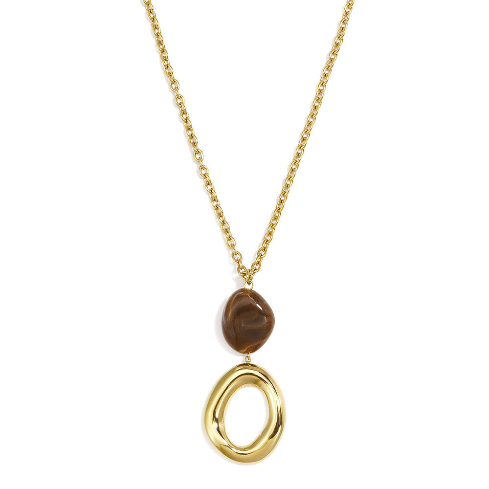 Long gold chain necklace with a marbled brown bead and sculptural open oval gold pendant.